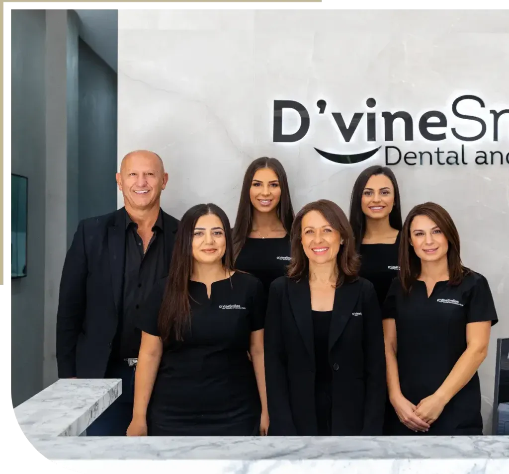 D'vine Smiles dental team posing at the front desk