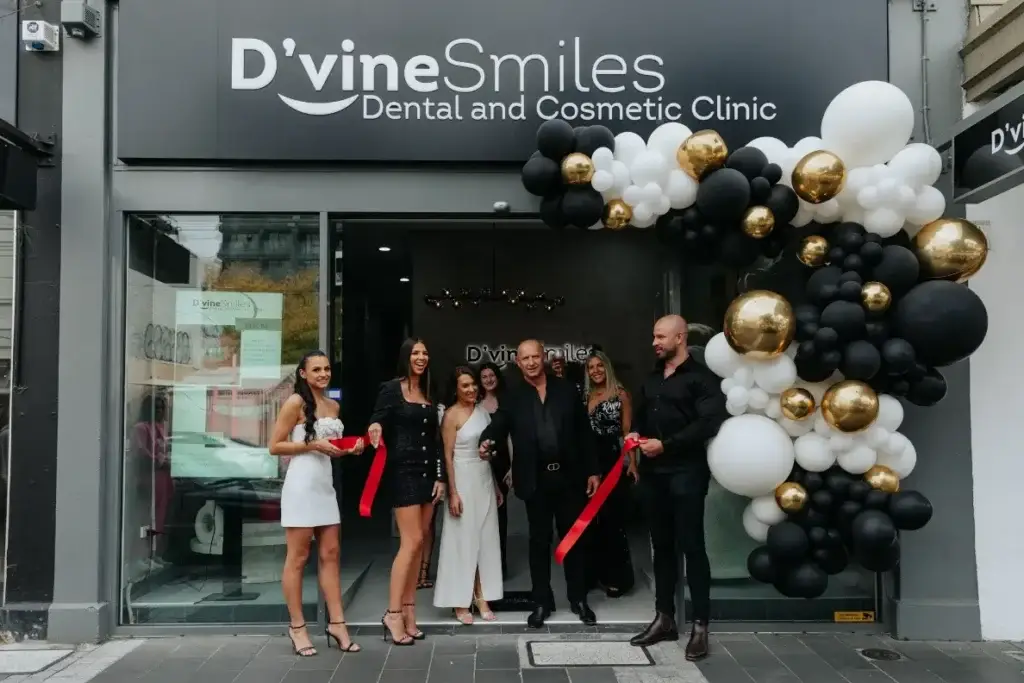 Dental team of D'vine Smiles posing at the clinic entrance