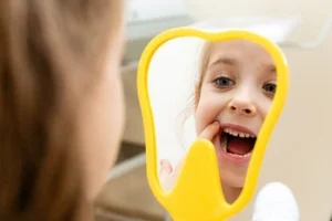baby girl looking at herself in the mirror